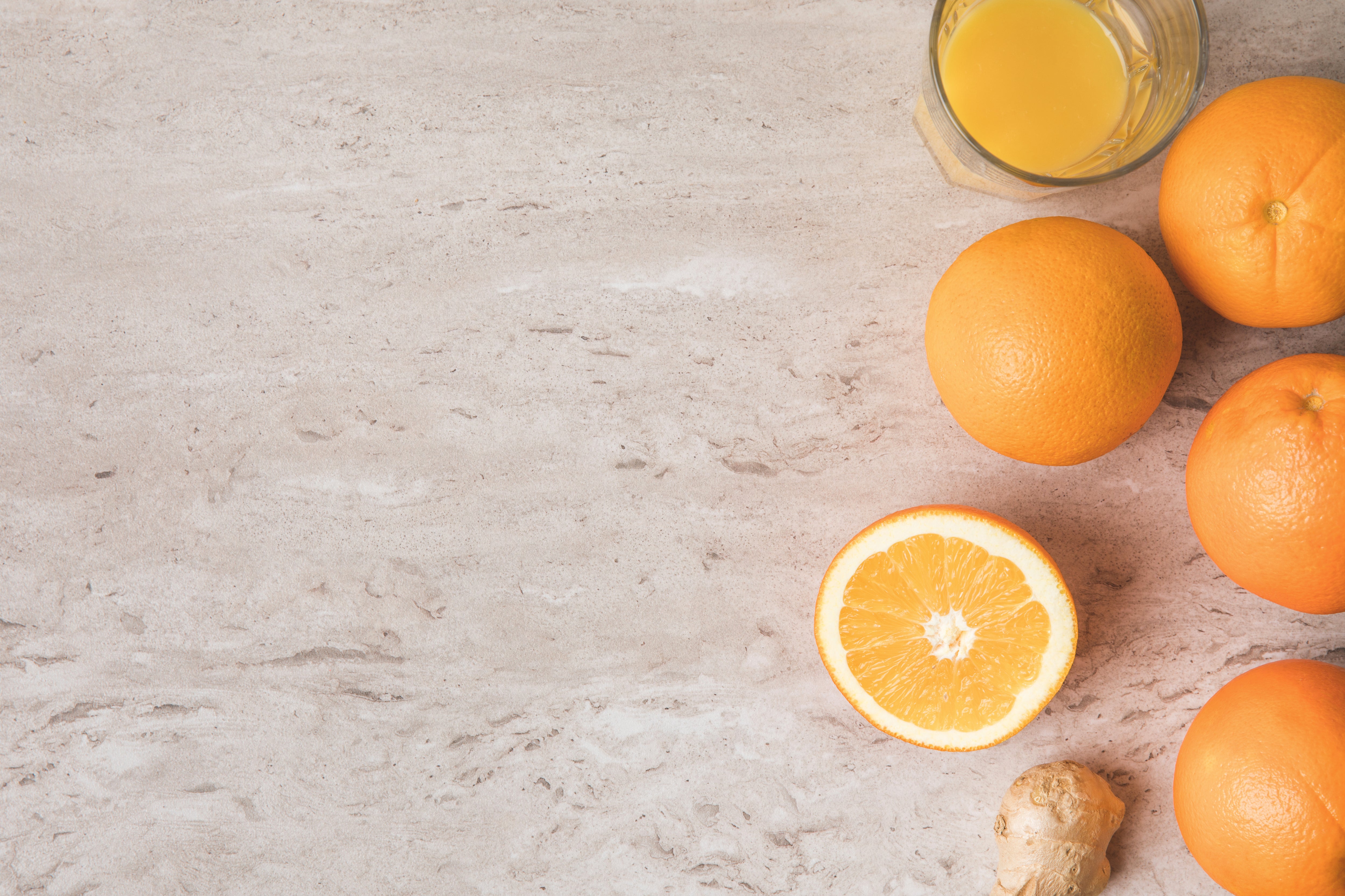 Free Photo  Fresh orange juice in the glass on marble background